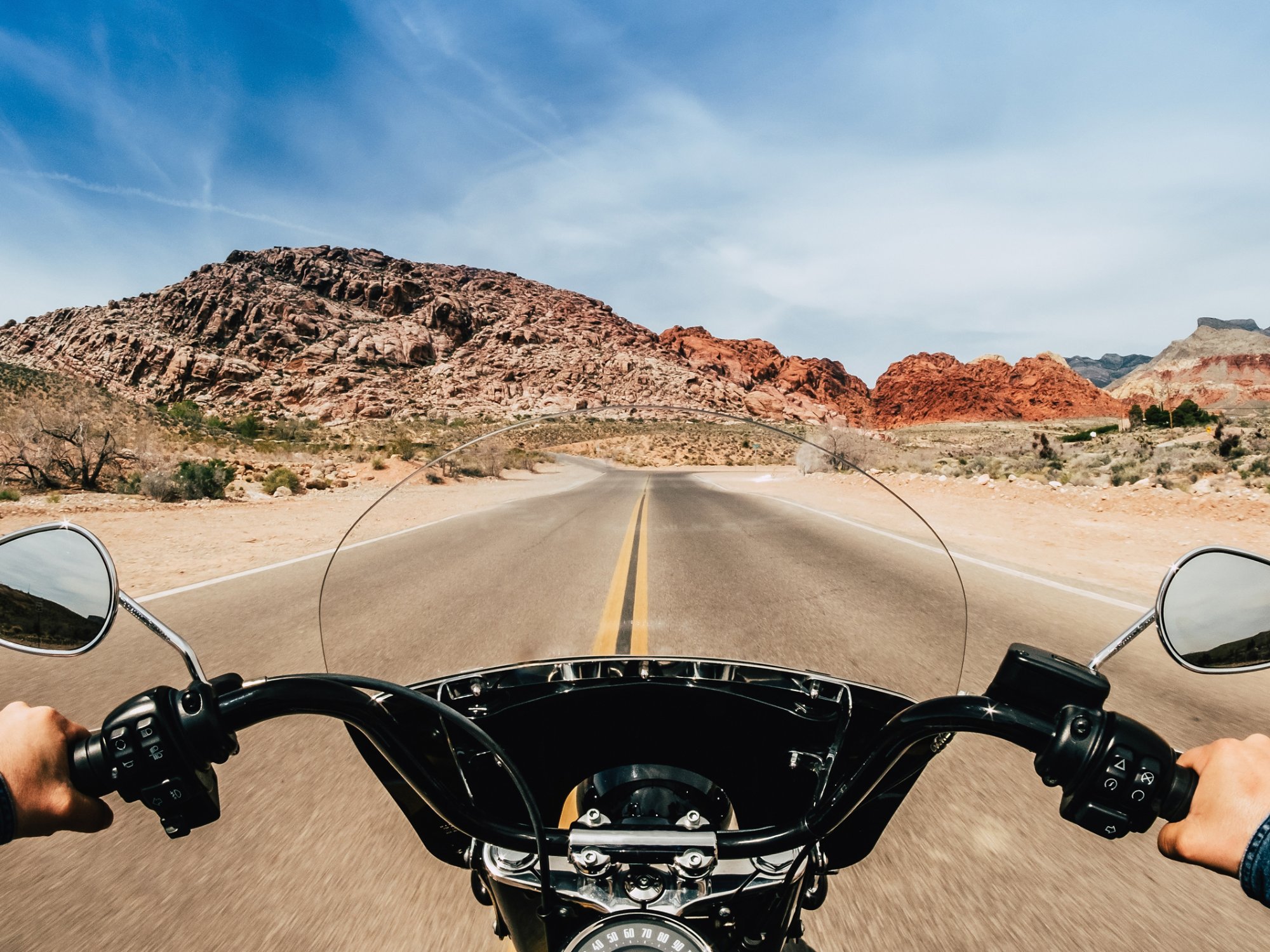 First person view of a man driving a motorcycle on a road